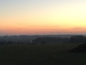 Scenic view of field against sky during sunset