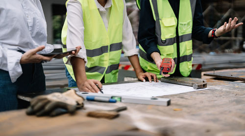 Midsection of business people working at office