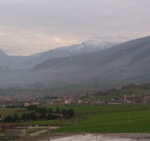 Scenic view of agricultural field and mountains against sky