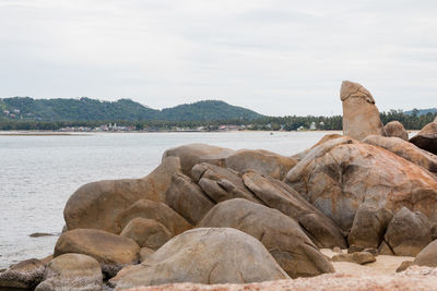 Rocks on beach against sky