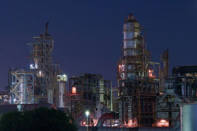 Low angle view of illuminated buildings against sky at night