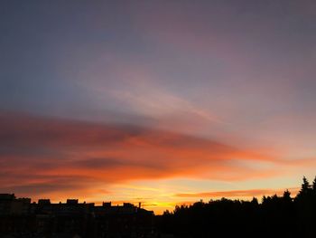 Silhouette buildings against sky during sunset