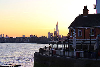 Buildings in city at sunset