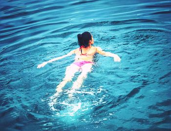 Rear view of woman in swimming pool