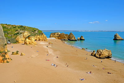 Scenic view of beach against blue sky