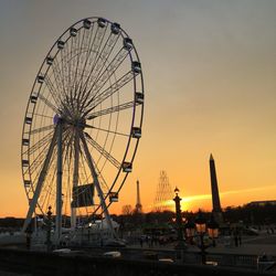 Low angle view of ferries wheel at sunset