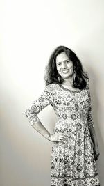 Portrait of a smiling young woman against white background