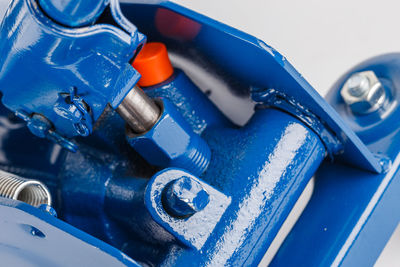 Close-up view on hydraulic valve and piston of floor car jack