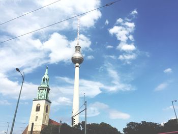 Low angle view of tower against cloudy sky