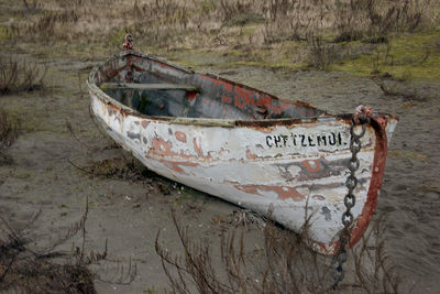 Text on old boat at sea shore