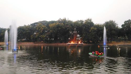 Man on boat in water against sky