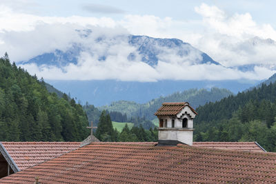 Houses on mountain against sky