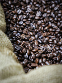 Close-up of roasted coffee beans in sack in store