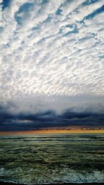 Scenic view of sea against cloudy sky