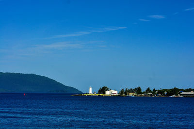 Scenic view of sea against blue sky