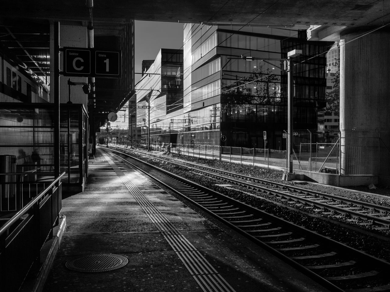 track, rail transportation, railroad track, transportation, architecture, built structure, building exterior, railroad station, mode of transportation, no people, direction, public transportation, railroad station platform, the way forward, outdoors, nature, city, day, illuminated, travel, long