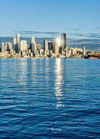 The sun reflects from buildings in the skyline of seattle, washington.