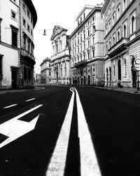 Road amidst buildings against sky in city
