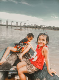 Friends sitting by water