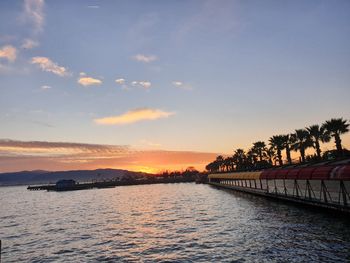 Scenic view of river against sky at sunset