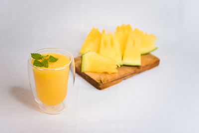 Close-up of drink on table against white background