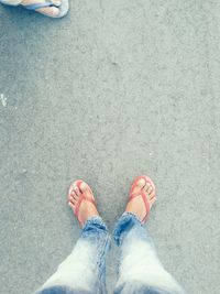 Low section of person standing on footpath