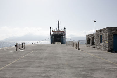 Scenic view of building by sea against sky