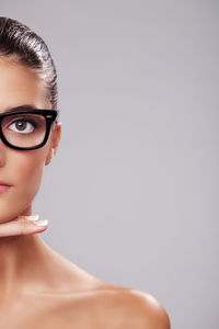 Close-up of young woman against white background