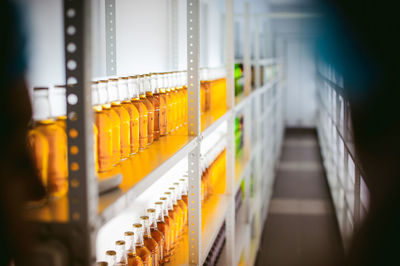 Liquid in bottles arranging in shelf at supermarket