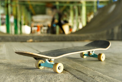 Close-up of skateboard on skateboard park