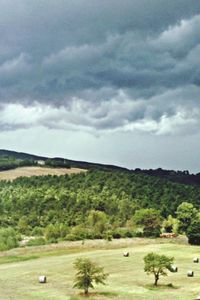 Scenic view of mountains against cloudy sky
