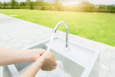 Low section of woman washing hands