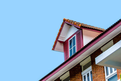 Low angle view of house against clear blue sky