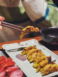 Cropped hand of person preparing food