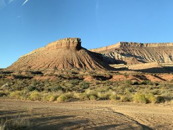 Scenic view of arid landscape against clear sky