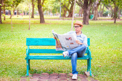 Man sitting on bench in park