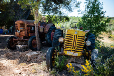 Abandoned tractor on field against sky