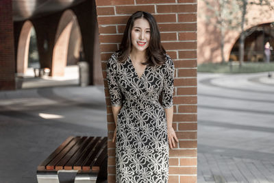 Portrait of young woman standing outdoors