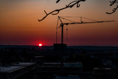 Silhouette buildings against sky during sunset