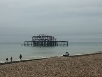 People on beach against sky