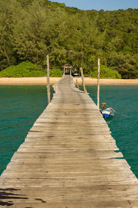 Wooden pier leading towards sea