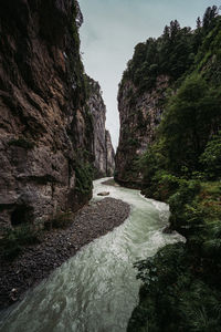 Scenic view of waterfall against sky