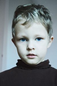 Portrait of cute boy standing at home