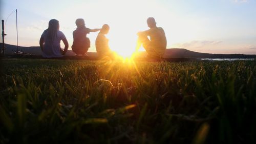People standing on grassy field