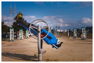 Deck chairs on beach against sky