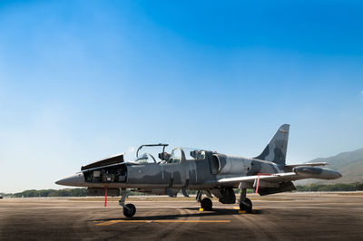 Airplane on runway against clear sky