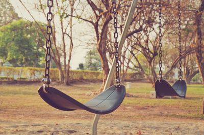 Close-up of swings at park 