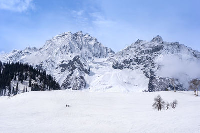 Scenic view of snow covered mountains against sky