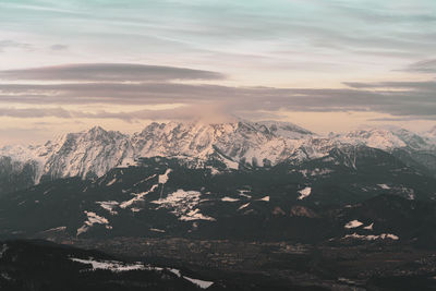 Scenic view of snowcapped mountains against sky during sunset