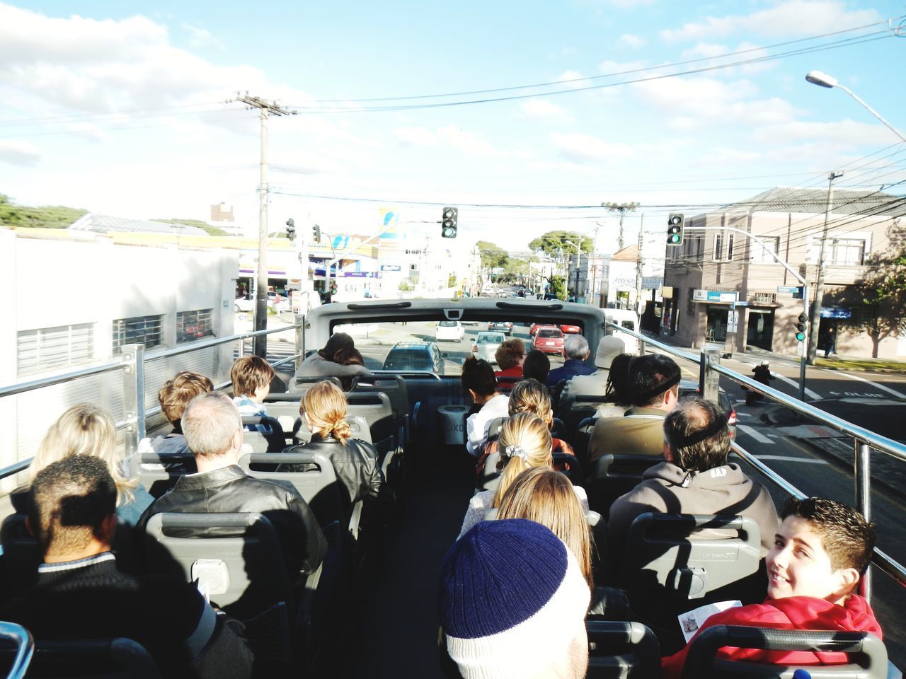 REAR VIEW OF PEOPLE ON STREET AGAINST SKY